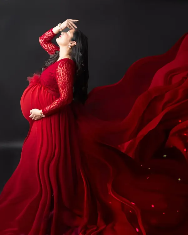 A truly powerful and dramatic portrait. The way the red fabric of the gown flows looks like liquid fire, creating an unforgettable image of strength and beauty.