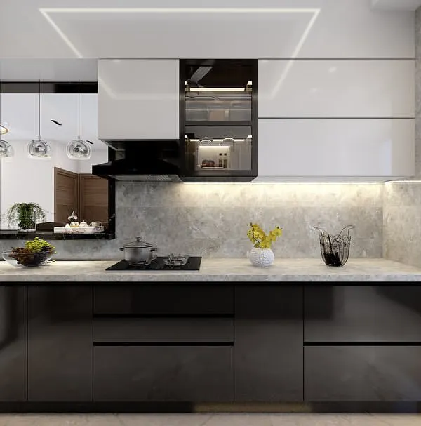 A clean and functional monochrome kitchen. The glossy black lower cabinets contrast beautifully with the white upper cabinets and marble-patterned walls.