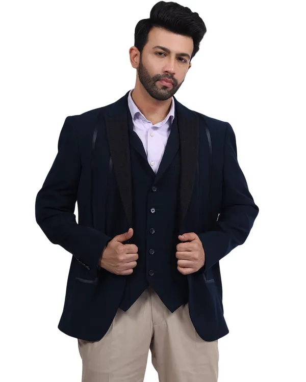 A male model in a sharp navy blue three-piece suit, shot against a clean white background for a classic e-commerce catalogue look.
