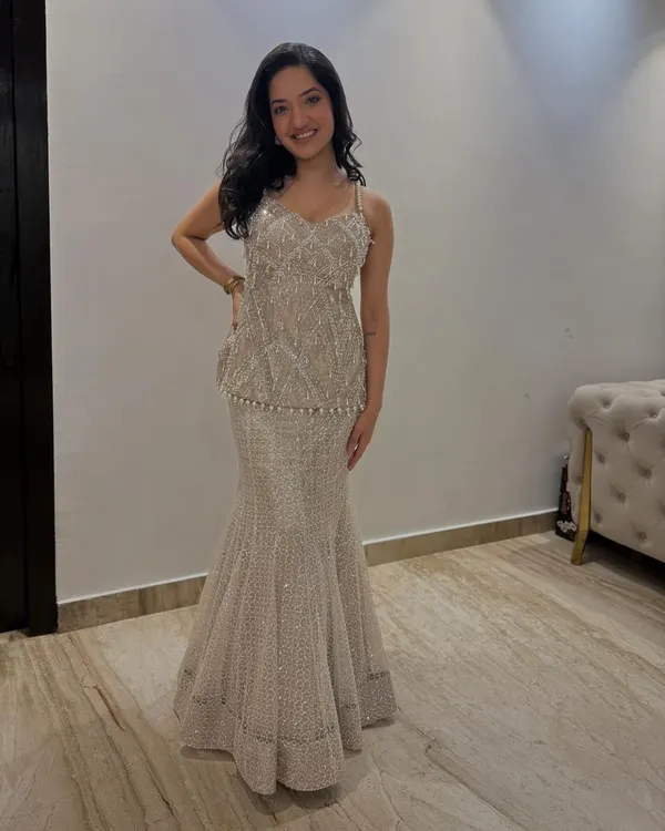 A client looking like a dream in our beaded peplum top and skirt set. This Indo-Western silhouette is perfect for a sangeet or cocktail party, offering glamour and comfort.