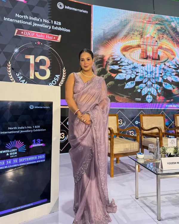 Poised and ready by the stage at the International Jewellery & Gem Exhibition, a premier B2B event.