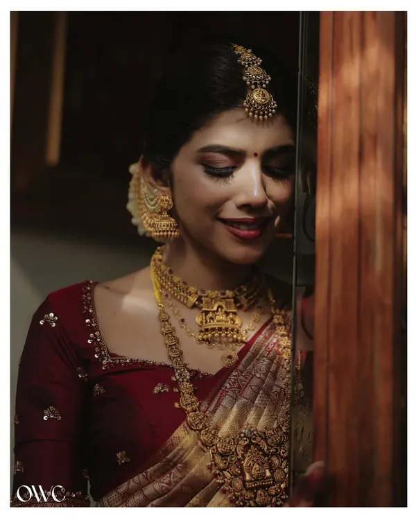 A timeless bridal portrait. We use soft, dramatic lighting to highlight the intricate details of the bride's temple jewellery and the serene expression on her face.