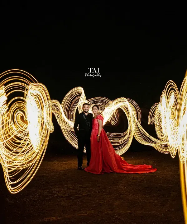 We created magic with light painting in this dramatic night shoot. The golden swirls of light wrap around the couple, creating a stunning visual effect that is both energetic and romantic.