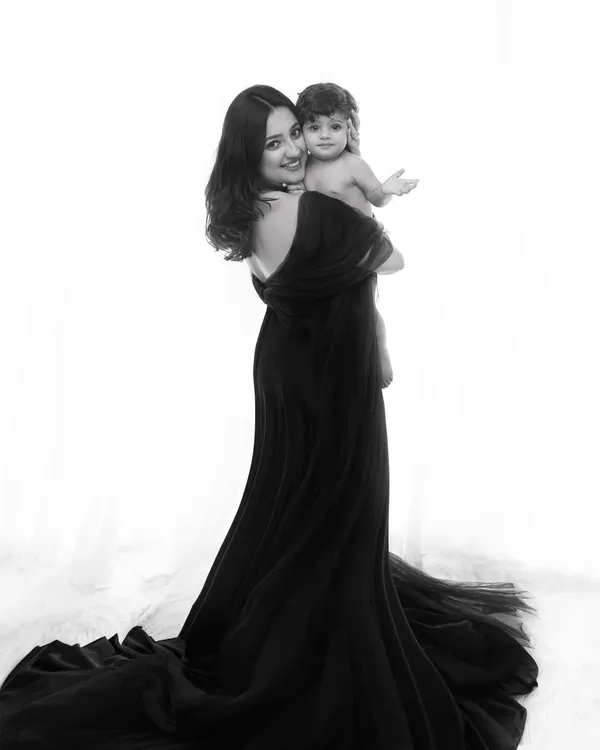 A timeless black and white portrait celebrating the bond between a mother and her child. The dramatic silhouette and elegant styling create a piece of fine art for your family.