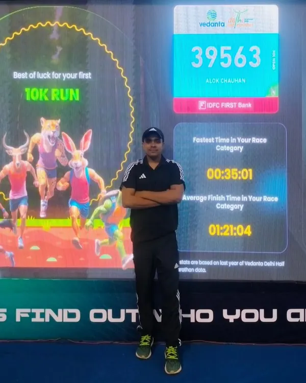At the Vedanta Delhi Half Marathon expo, checking my stats from previous years. I am always looking to improve, just like I push my clients to do.
