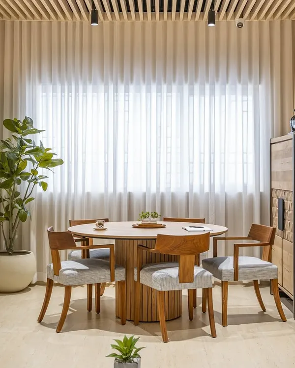 The Director's Room in 'The Terra Office' is designed for collaboration and leadership. A central round table, clean wooden interiors, and sheer curtains create an inspiring hub for innovative discussions.