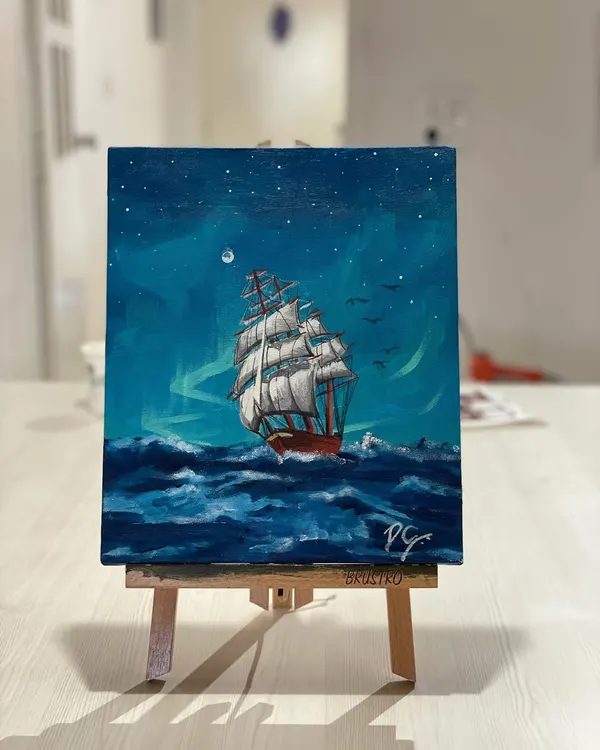 A stunning acrylic painting of a ship on the high seas, created by a participant in one of our open studio sessions. The detail in the waves and sails is incredible.