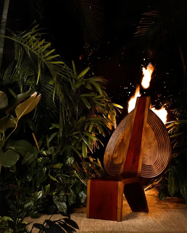 The Vismayam chair, photographed here with fire, evokes the spirit of Theyyam, the ritual art form that inspired it. The chair is an embodiment of the reverence and awe we feel for this powerful cultural tradition.
