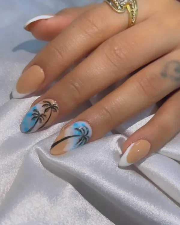 Ready for Goa! I hand-painted these beach-themed nails with palm trees against a blue sky, paired with a nude and white French manicure.