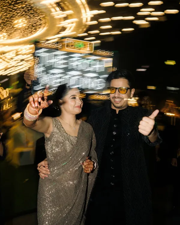 A fun, high-energy shot of the couple on the dance floor, captured with a slow-shutter effect to convey motion and excitement. This is perfect for capturing the party vibe.