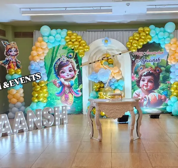 A complete stage setup for a Little Krishna themed naming ceremony. We designed this with a custom backdrop, character cutouts, a traditional cradle, and large marquee letters spelling out the baby's name, creating a grand welcome.
