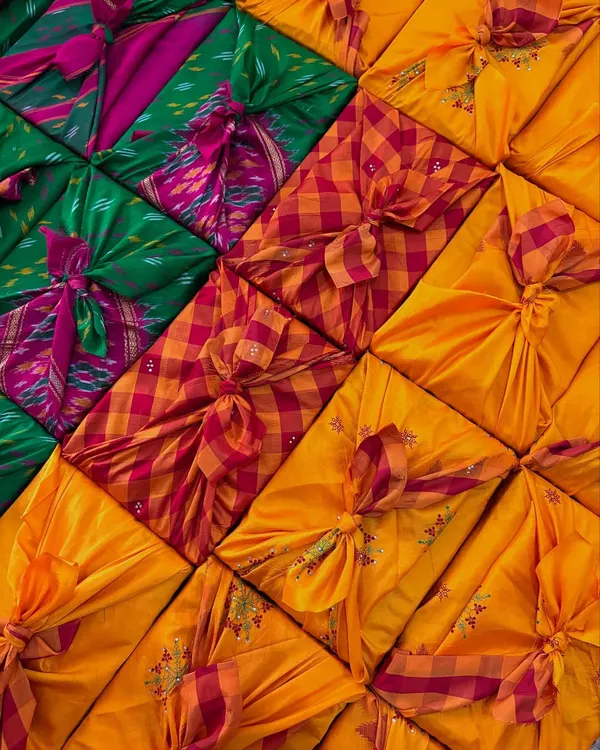 This is my favorite way to wrap. We use beautiful old sarees, sent by the client or sourced by us, and tie them in the Japanese Furoshiki style. It’s a completely waste-free method that turns the packaging into a reusable gift itself.