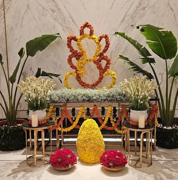 This elegant Ganesh installation was created for the lobby of the Fairmont hotel in Mumbai. I used yellow and orange marigolds to craft the central figure, complemented by white tuberoses and large tropical plants for a balanced and respectful display.