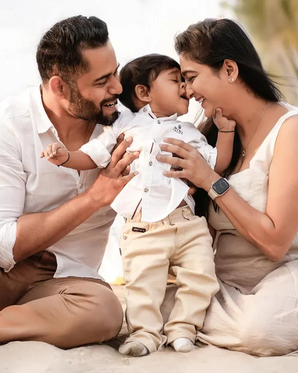 We believe the most beautiful family portraits are the ones where you forget the camera is even there. This candid moment on the beach, with warm embraces and genuine smiles, is the essence of what we love to capture.
