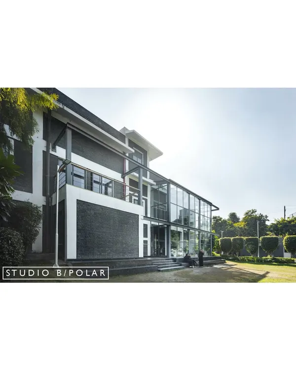The exterior of the Media Monks campus in Noida, a 100,000 sq. ft. project we completed in 12 months. Our design refreshed the existing buildings and emphasized a seamless connection to the central lawn and surrounding landscape.