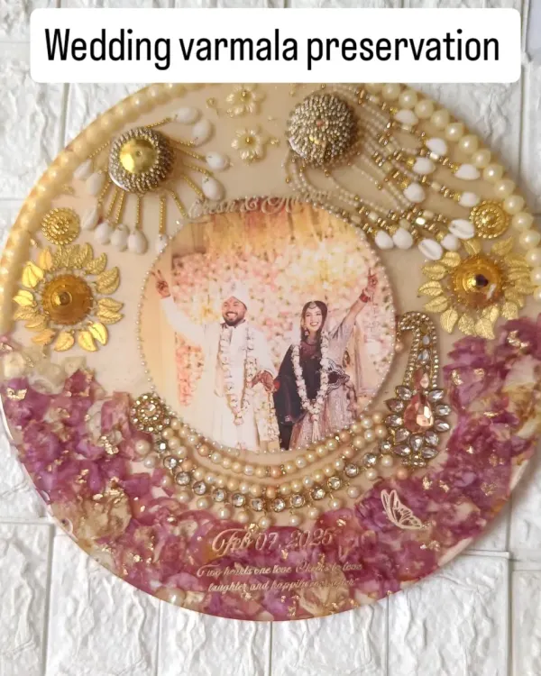 This beautiful round frame holds so many precious wedding day memories. I carefully preserved the couple's varmala flowers and bridal kaleere, arranging them around their favorite photo to create a piece they can cherish forever.