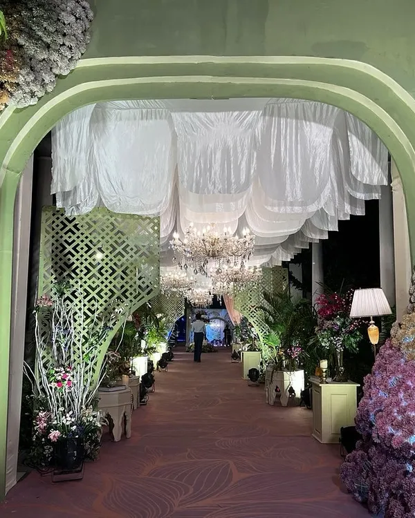 A grand entrance to a magical evening. I designed this arched walkway with massive floral installations and a ceiling of soft, white drapes and chandeliers to create an unforgettable first impression.