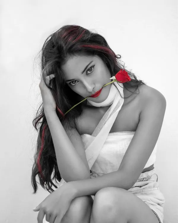 An artistic portrait using a selective color technique. By keeping the image monochrome except for the red rose, lips, and hair, I created a dramatic and intense look that is both modern and timeless.
