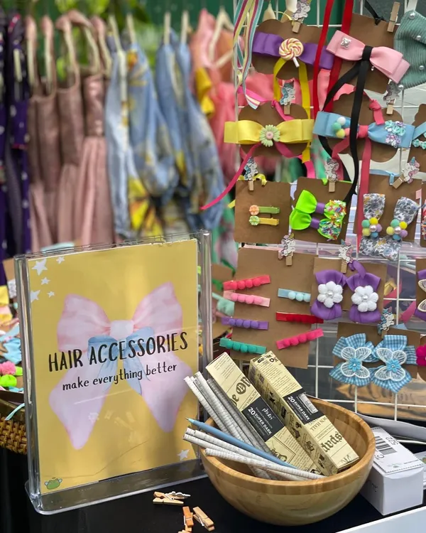 You'll find the most charming accessories at my events, like this adorable display of hair bows and clips. It’s the little details that make an outfit special, and I curate vendors who excel at them.