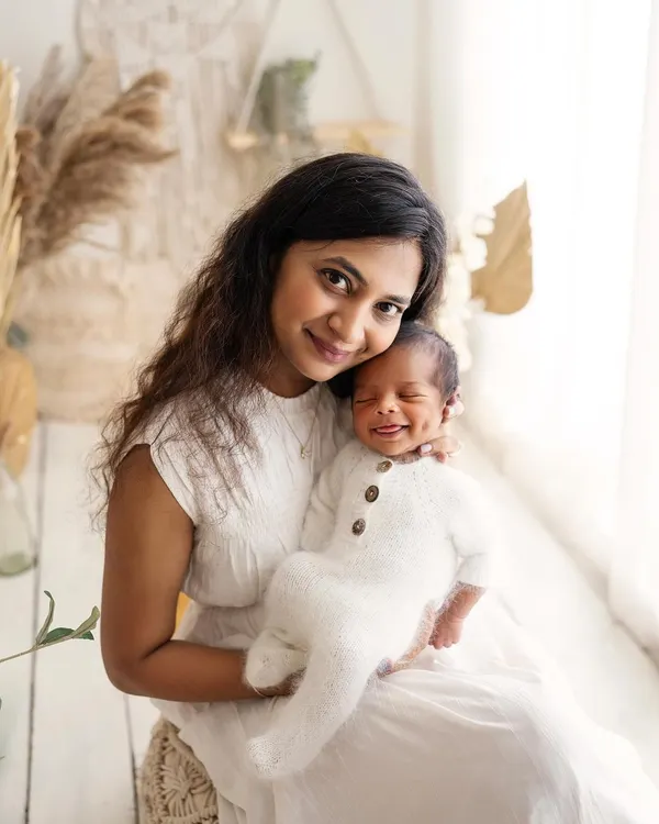 Just look at that dimple! This beautiful mom is holding her smiling baby, and the connection between them is just radiant.