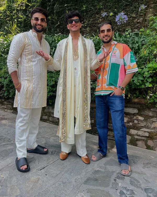 YouTuber Nischay Malhan celebrating in our custom off-white kurta set. The outfit features a long kurta with a matching stole, both adorned with beautiful mirror work.