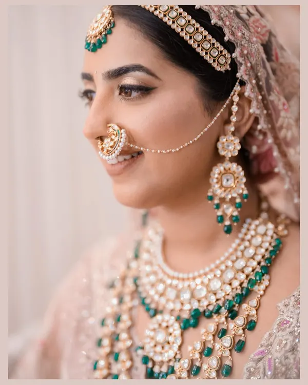 A bride's jewelry tells a story of heritage and personal style. I guided the selection of this intricate kundan and emerald set, ensuring it complemented the pastel Tarun Tahiliani outfit and completed a look of regal elegance.