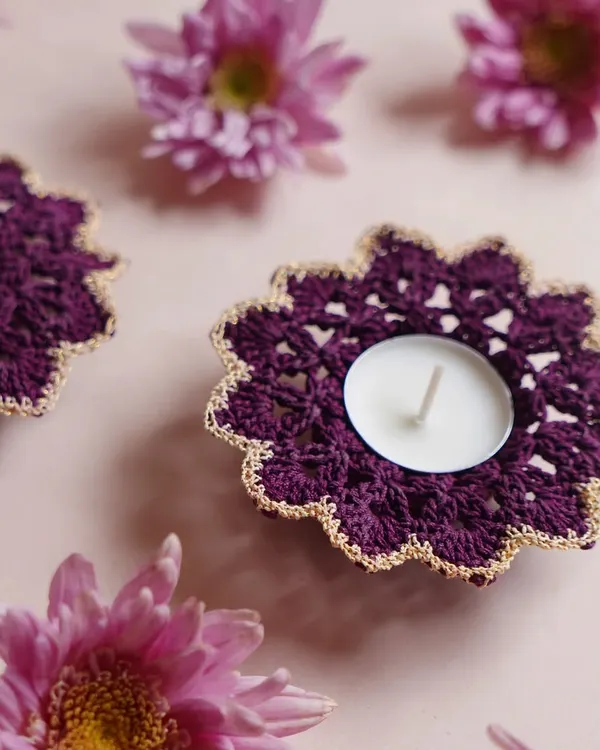 Our elegant purple crochet diya coasters with a delicate gold trim. These are designed to hold standard tea lights and add a touch of handmade luxury to your Diwali decor.