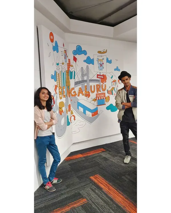 Posing with our finished mural for Xiaomi India's office in Bengaluru. This custom doodle art covers a corner wall and is filled with icons that celebrate the city.