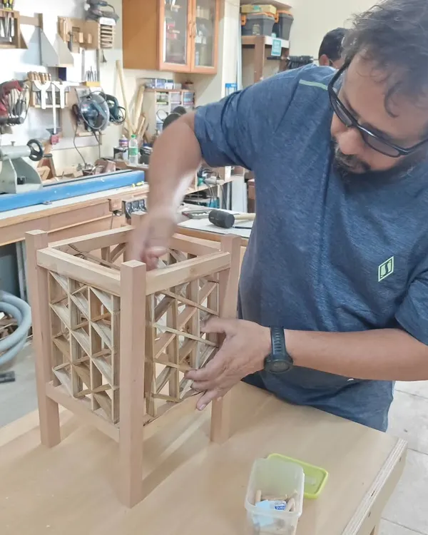 Here's a student working on a triangle grid Kumiko lamp. This technique requires immense focus as each small piece is carefully fitted. It's a rewarding process that results in a truly unique piece of decor.
