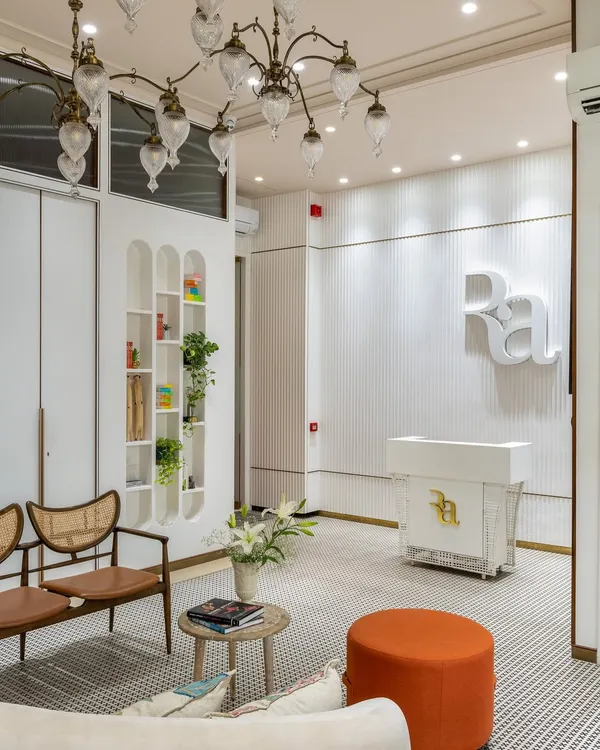 The reception at Ra Clinic sets a serene and luxurious tone from the moment a client arrives. I used fluted white walls, a custom reception desk, and elegant arched shelving to create a clean, sophisticated look. The space is designed to be a calming welcome, blending comfort and high end aesthetics seamlessly.