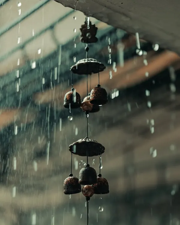 The sound and sight of rain from my new home. I love capturing these moody moments, like the water droplets falling from the wind chimes, which create a sense of peace and nostalgia.