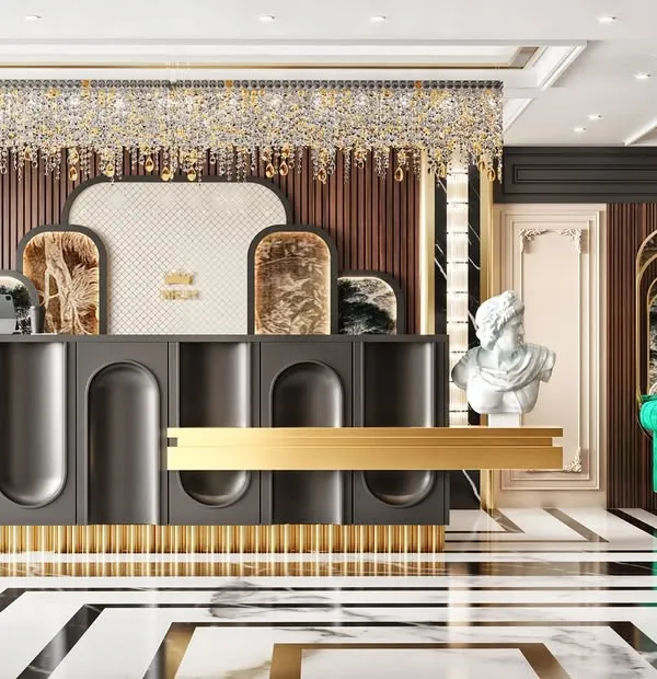 A wide shot of the jewellery showroom's reception and waiting area. The image showcases the custom-designed desk with gold accents and the luxurious green velvet sofa.