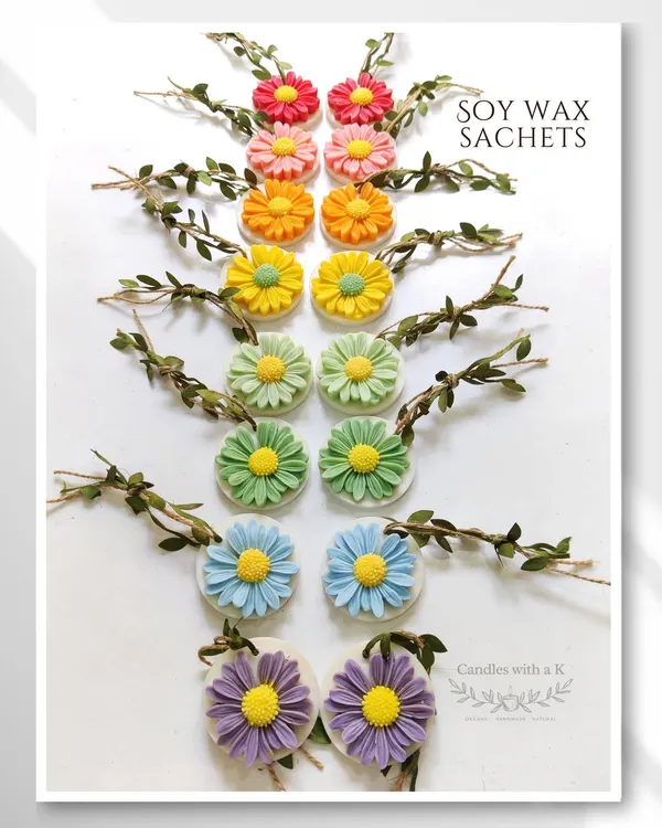 A rainbow of my daisy flower soy wax sachets, a beautiful and fragrant alternative to candles for return gifts.