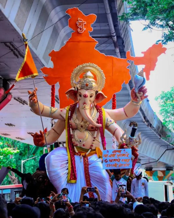 This is one of my proudest creations, a grand Ganpati idol for a public festival. The procession shows the scale of the celebration and the central role the murti plays, standing tall with a backdrop of Bharat, surrounded by devotees.
