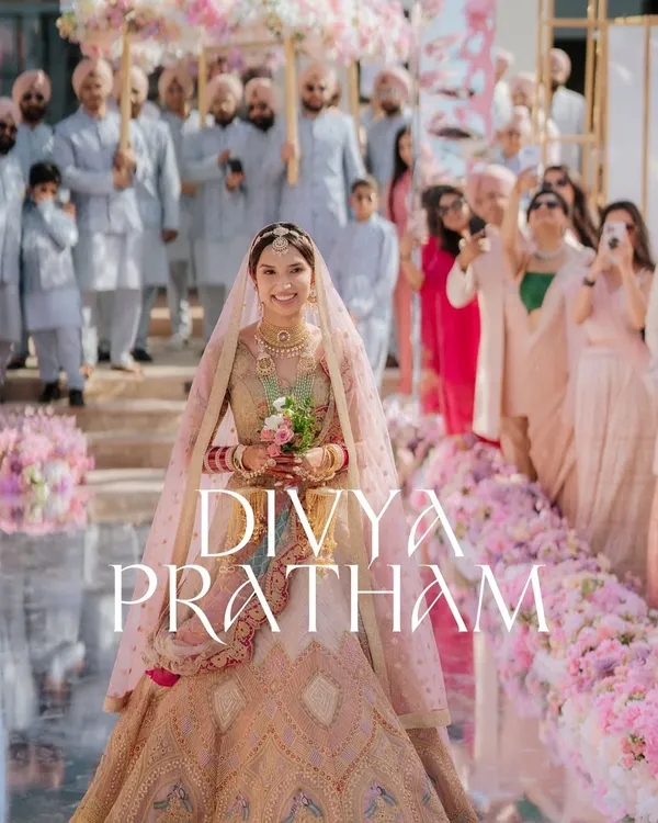The bride's grand entrance. I captured this moment on a mirrored aisle, surrounded by family and a sea of pink flowers, creating a truly breathtaking photograph.