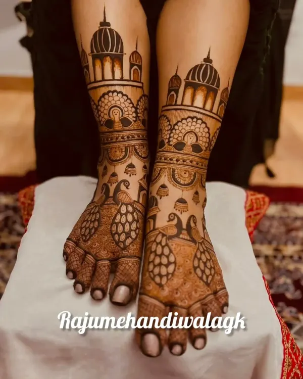 A matching set of hand and feet mehendi. The feet feature the same palace domes and peacock motifs as the hands, creating a cohesive and royal look.