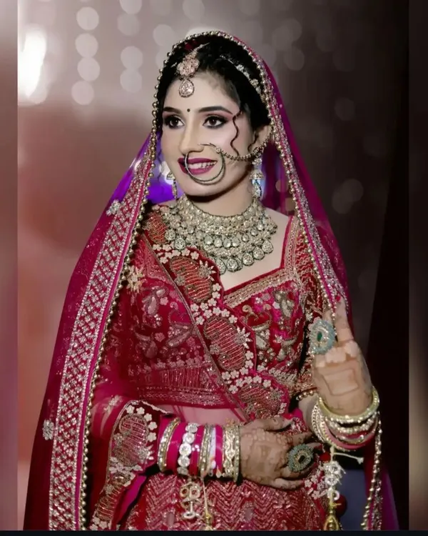 A stunning bride on her wedding day. Her smile and the way her mehndi complements her jewelry and outfit is everything!