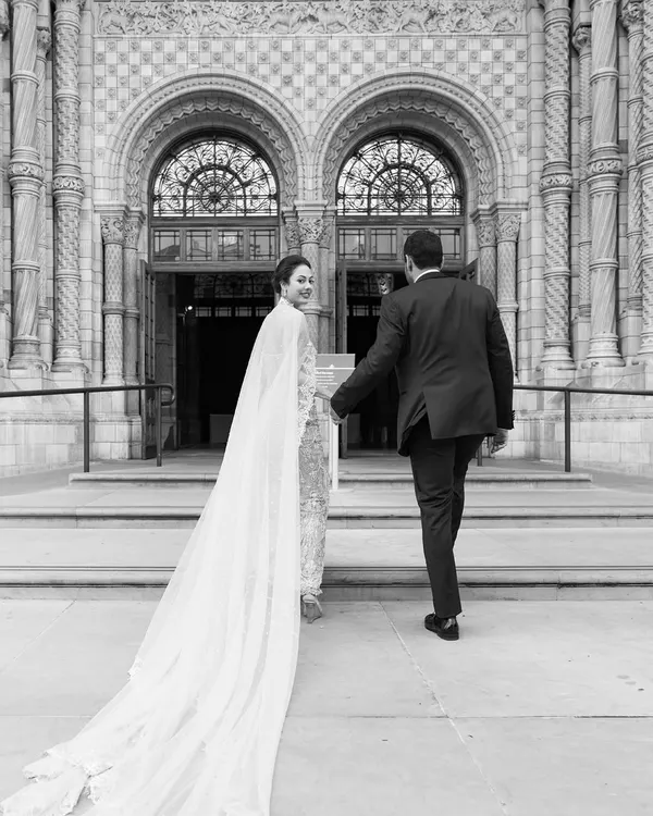 A grand entrance into a new life together. This shot captures the couple's descent into their magnificent reception at the Natural History Museum in London.