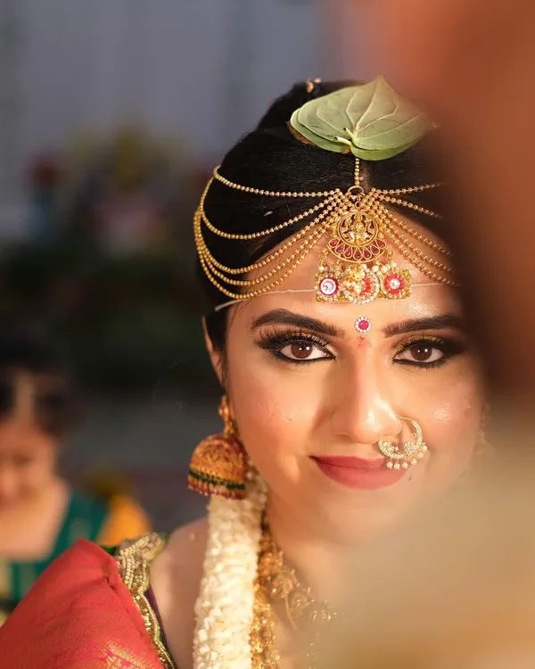 A classic South Indian bridal look, focusing on radiant skin and captivating eyes. This is all about creating that timeless, elegant glow for your big day.