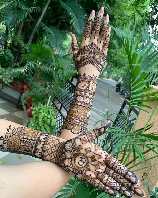 A perfect example of an engagement mehndi design. It's full and intricate, with personalized initials, but still allows for movement and comfort during the ceremony.