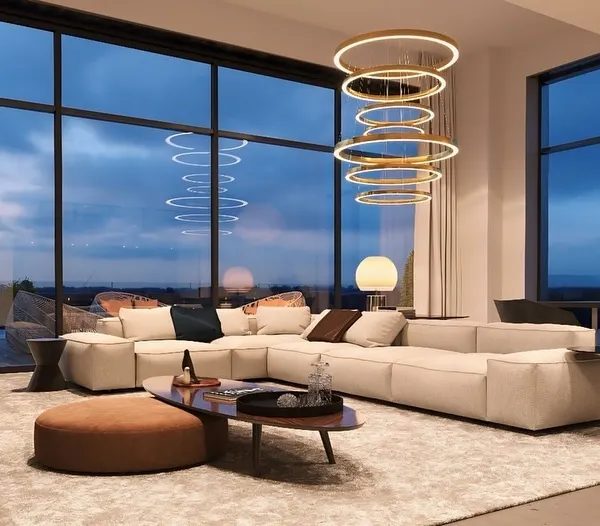 This is the interior of a custom-designed rooftop lounge in Delhi NCR, featuring floor-to-ceiling glass walls that offer panoramic city views. The design emphasizes modern luxury and comfort, creating an aspirational living space that is fully protected from the elements.
