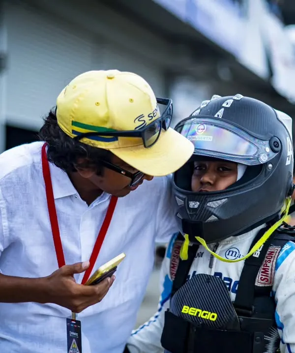 We believe that racing is built on a foundation of trust and mentorship. Here, one of our coaches provides last minute guidance to a young driver before he heads out on track, ensuring he is focused, confident, and ready for the challenge ahead.