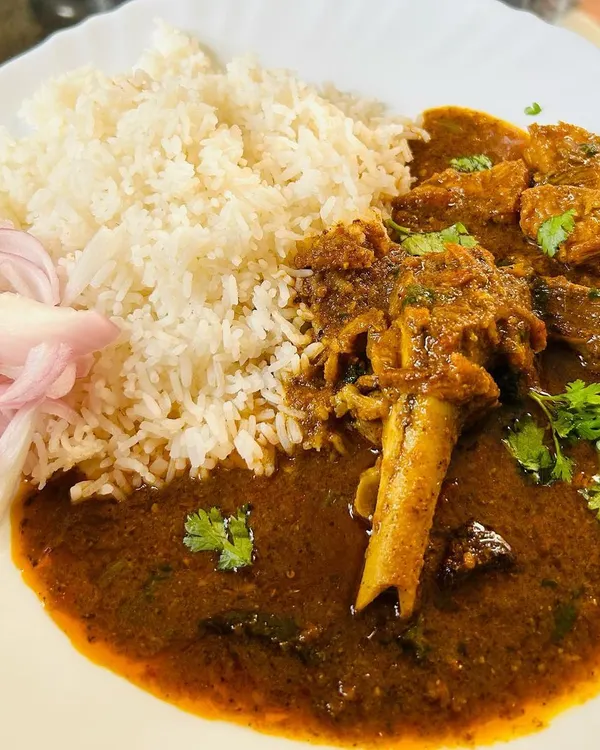 My signature Mutton Curry, slow-cooked for hours until the meat is tender and falling off the bone. The thick, spicy gravy is made with my special blend of home masalas and is perfect with a plate of simple steamed rice.