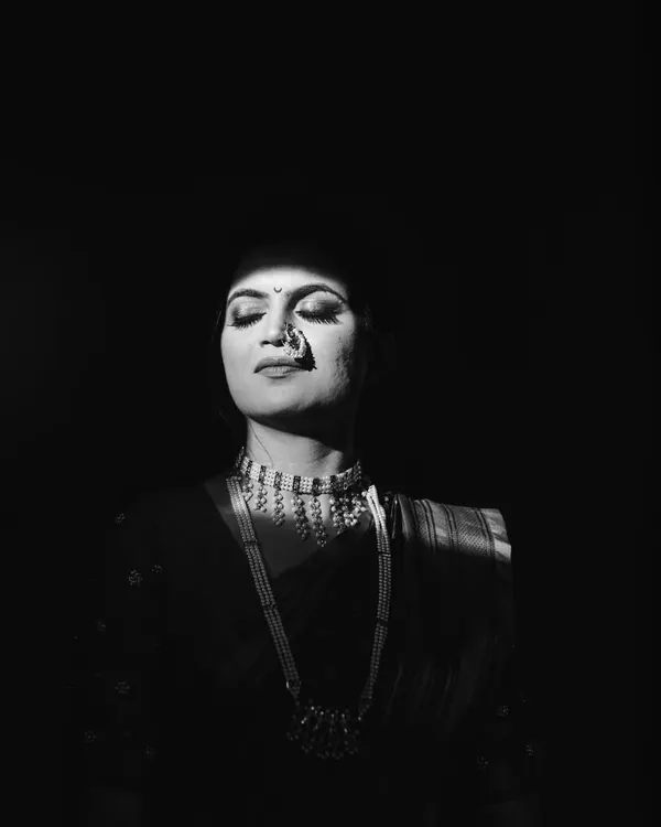 I love playing with light. For this bridal portrait of Kinjal, I used a sliver of morning sunlight coming through a window to create this dramatic, high contrast black and white image. It’s simple, powerful, and all about her serene expression.