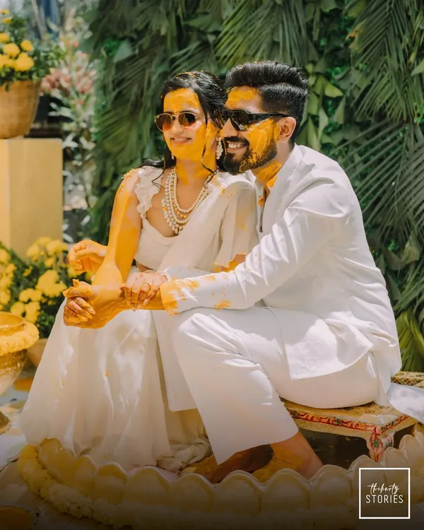The perfect Haldi portrait, with the couple looking cool and happy in their sunglasses, covered in turmeric. This shot captures the fun and modern vibe of their celebration.