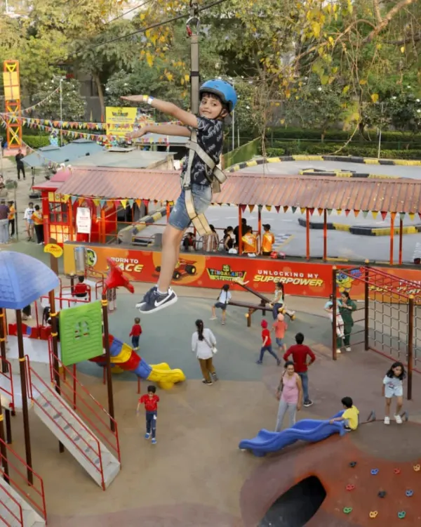 Feel the rush as you fly across our adventure park on the zipline. This bird's-eye view shows just a glimpse of the fun below, from the go-kart track to the colorful play structures.