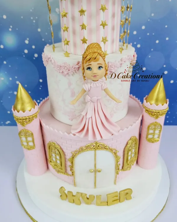 A close-up of the magnificent four-tier princess castle cake for Skylar's 3rd birthday. The design features intricate gold details, pink turrets, and a beautiful princess figurine.