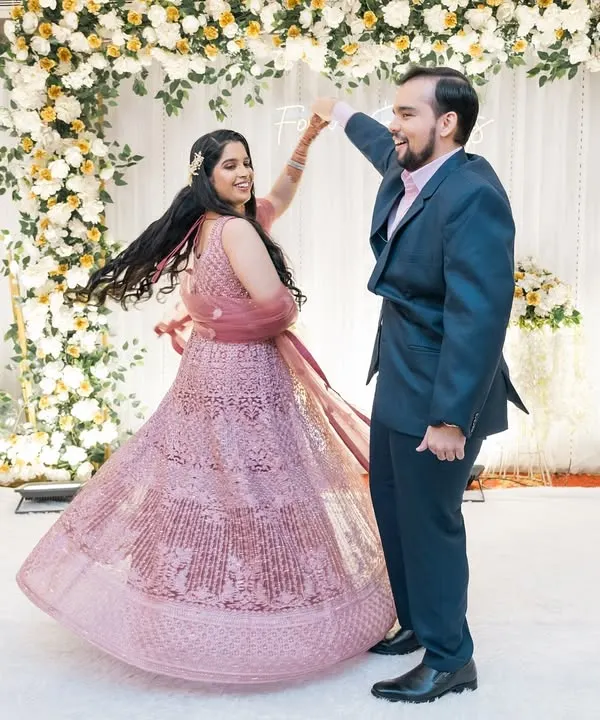 The first dance as husband and wife. The bride's twirling lehenga and the couple's happy faces make this a perfect reception shot.