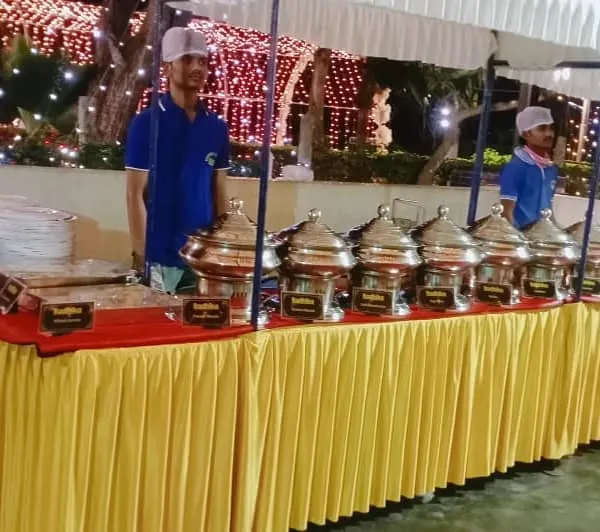 A full view of our buffet station at an evening wedding reception. We arrange everything neatly, from the plates to the series of food warmers, ensuring a smooth and organized service for your guests.