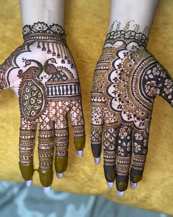 A perfect example of a design for the bridal party. This half-hand design features a beautiful peacock on one hand and an intricate mandala on the other.